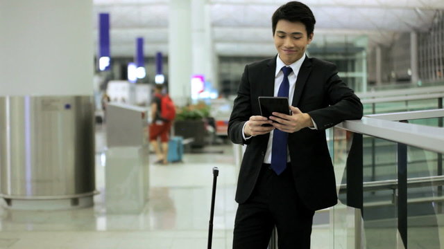 Male Asian Ethnic Business Traveller Airport Wireless Mini Tablet