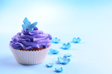 Delicious cupcake on blue  background