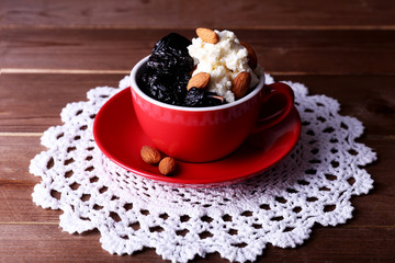 Dessert with prunes and almonds in red cup