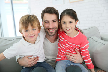 Portrait of cheerful daddy with kids