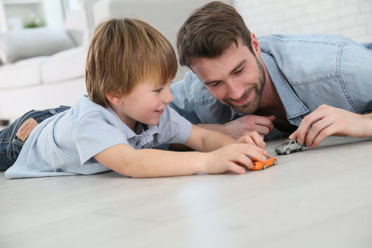 Daddy With Little Boy Playing With Toy Cars