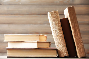 Stack of books on wooden planks background