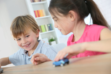 Kids playing with toy cars at home