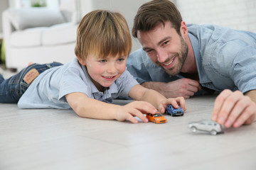 Daddy with little boy playing with toy cars © goodluz