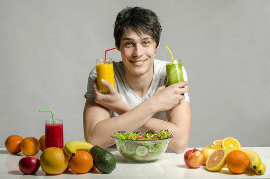 Man having a table full of organic food,juices and smoothie
