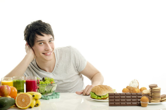 Man choosing between fruits, smoothie, healthy food and sweets