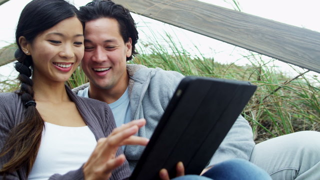 Asian Chinese Couple Warm Clothes Outdoors Beach Using Tablet