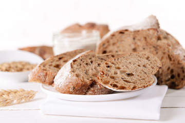 Tasty bread on table on light background