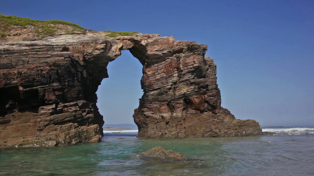 Stone arches on Playa de las Catedrales during outflow, Spain