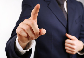 Businessman hand pushing screen, close-up