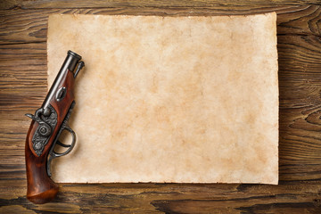 old parchment with pistol