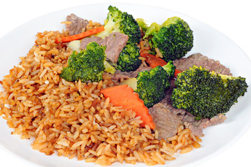 Beef meat, broccoli, carrots and rice with soy sauce on white pl