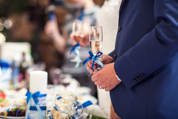Glasses with champagne in hands