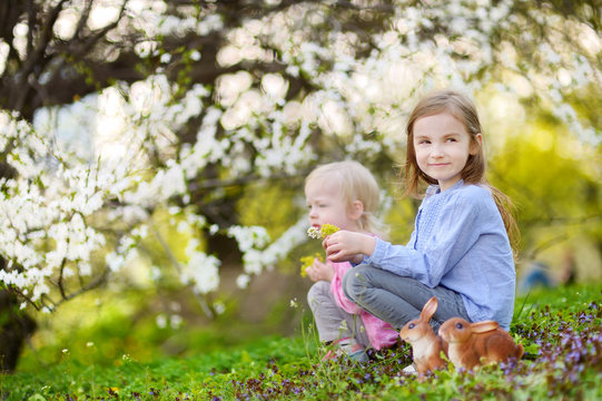 Two little girls playing in a garden on Easter