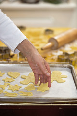 Frau mit roter Schürze backt Plätzchen in ihrer Küche