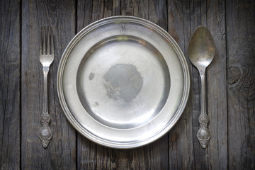 Old retro cutlery and plate on vintage boards