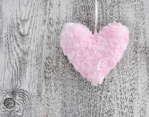 Fur pink heart on wooden background