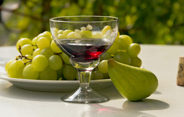 Still life- of a glass of wine,grapes and figs -outdoors.