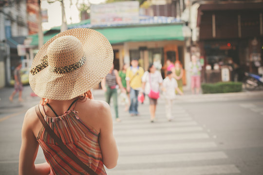 Young woman walking on th estreet in asian country