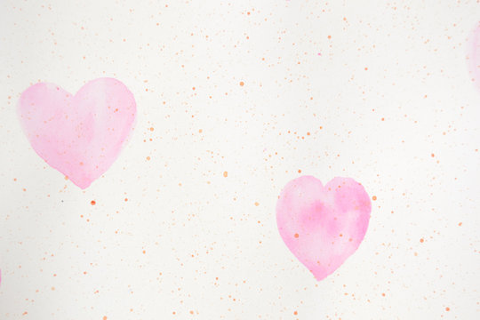 two painted pink hearts on a paper