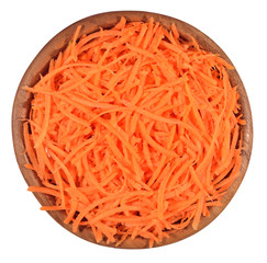 Chopped carrot in a wooden bowl on a white