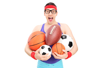 Nerdy guy holding a bunch of sports balls