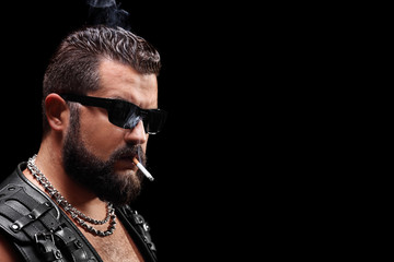 Studio shot of a biker smoking a cigarette
