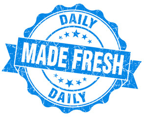 made fresh daily blue grunge seal isolated on white