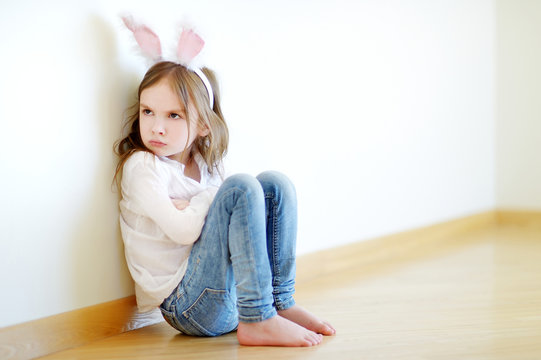 Angry little girl wearing bunny ears