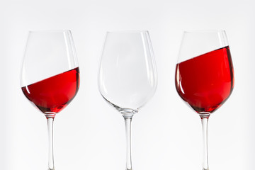 three red white wine glasses standing in a row