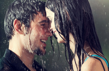 Couple hugging and kissing under a rain, outdoor