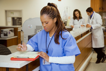 Hospital: Female Nurse Works On Test Results