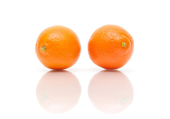 two tangerine isolated on white background with reflection