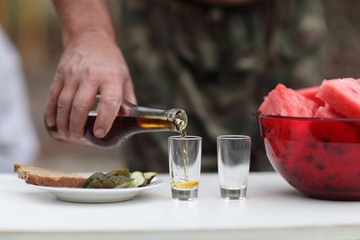Man filling glasses of brandy