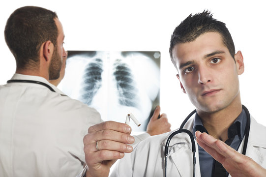 male doctor looking at the x-ray and advised to stop smoking