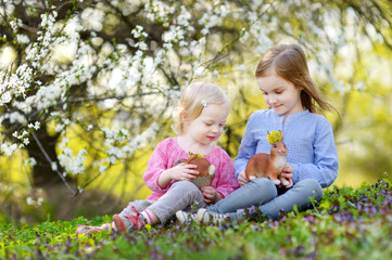 Two little girls playing in a garden on Easter