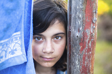 Young girl with expressive eyes, close-up portrait outdoors.