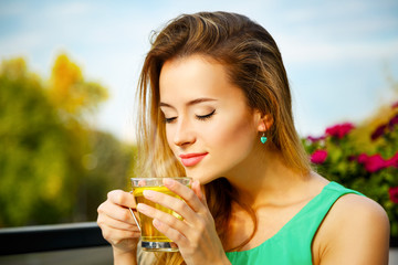 Young Woman Drinking Green Tea Outdoors - 77012706