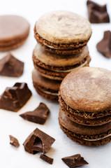 chocolate macaron with cream cheese on a white