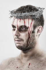 Bleeding man with crown of barbed wire