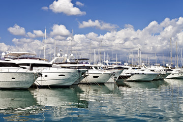 Row of luxury yachts mooring in a harbour