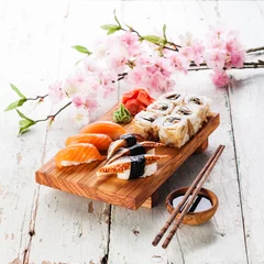 Zelfklevend Fotobehang Sushi Set: sashimi and sushi rolls on blue background © Natalia Lisovskaya