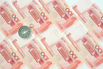 Yuan notes from China's currency. Chinese banknotes and compass