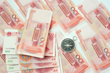 Yuan notes from China's currency. Chinese banknotes and compass
