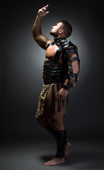 Fototapeta premium Image of handsome dancer posing as primitive man