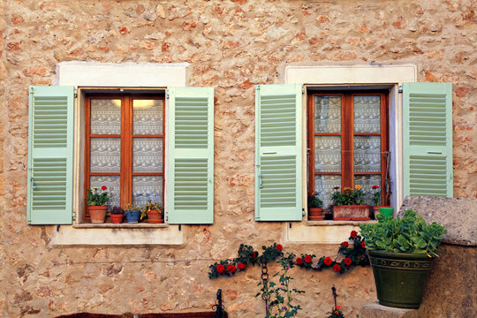 french rustic windows with old green shutters, Provence