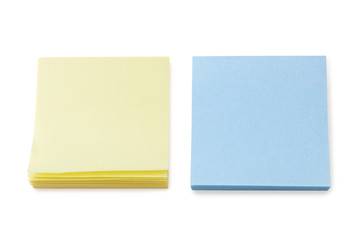 Stacks of blank yellow & blue Post-it notes, isolated