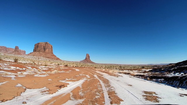 POV winter drive snow sun flare Colorado Plateau desert Monument Valley Arizona USA