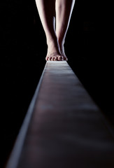 feet of gymnast on balance beam