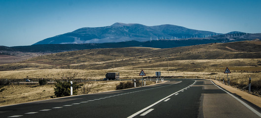 Landscape of treeless hillsides along the highways of Spain.